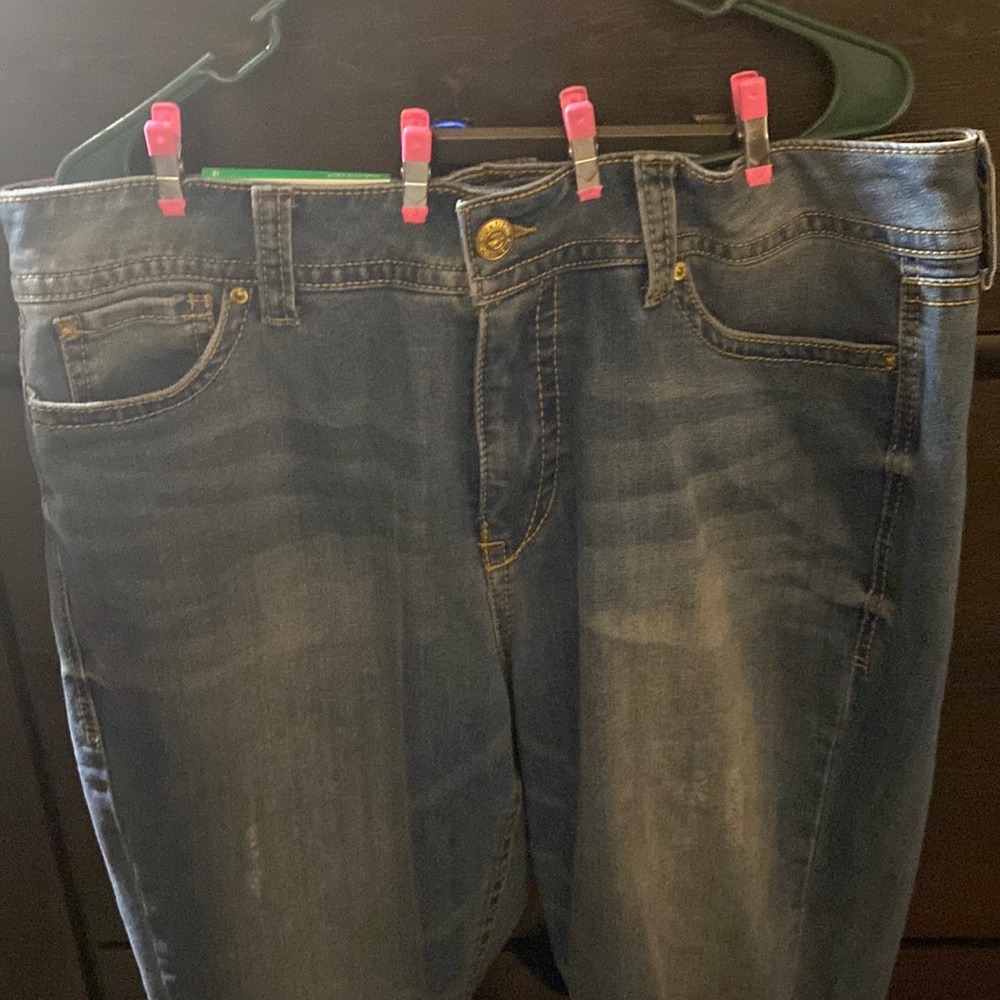 Cropped jeans with roll up at bottom rip on the knee. New never worn